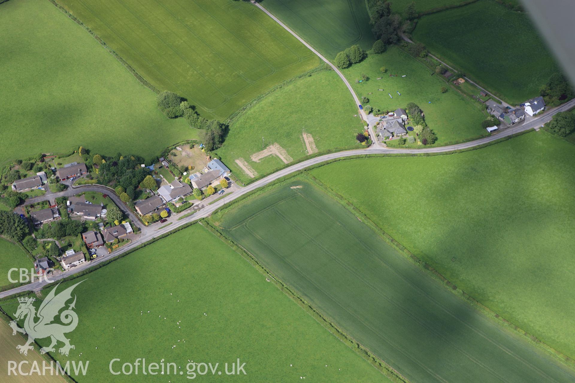 RCAHMW colour oblique aerial photograph of Walton Green Cursus showing trenches excavated by the Clwyd-Powys Archaeological Trust. Taken on 11 June 2009 by Toby Driver