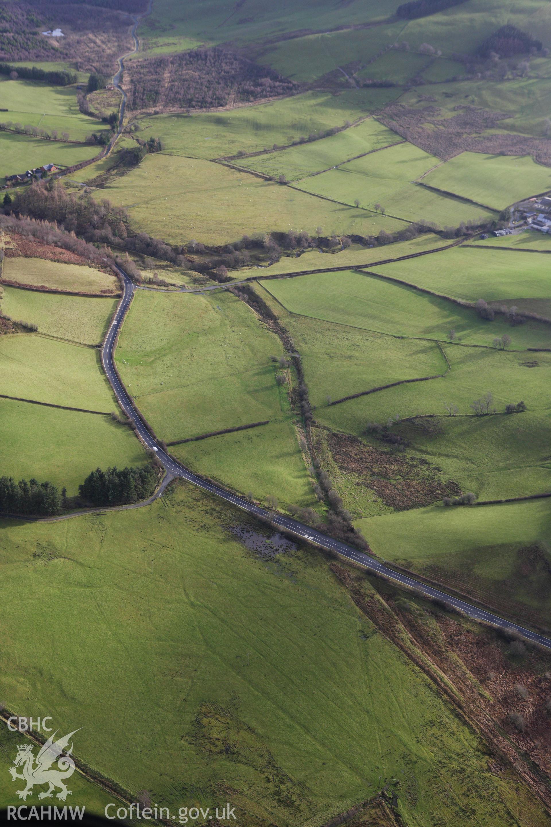 RCAHMW colour oblique aerial photograph of a section of the dismantled Manchester and Milford Railway between Llangurig and Llanidloes. Taken on 10 December 2009 by Toby Driver