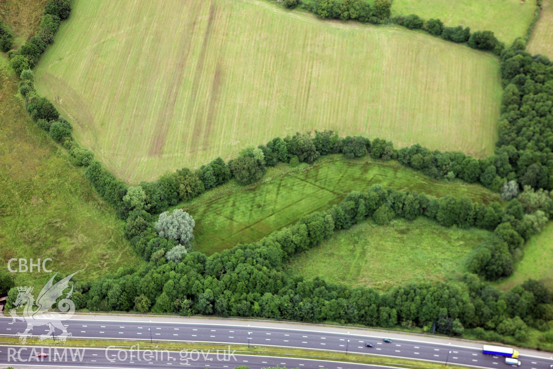 RCAHMW colour oblique aerial photograph of Ford Farm Roman Villa, Langstone. Taken on 09 July 2009 by Toby Driver