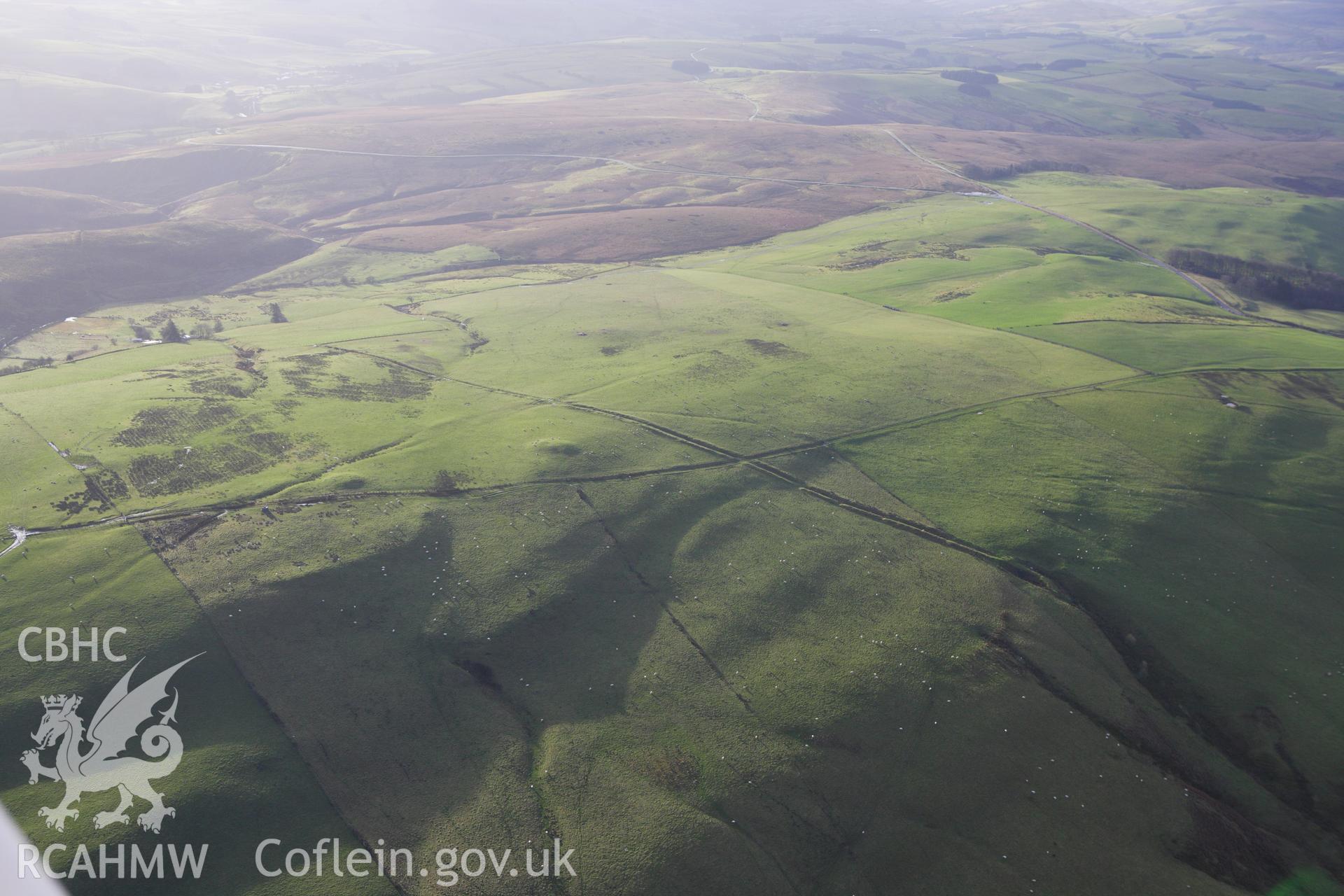 RCAHMW colour oblique aerial photograph of Two Tumps Dyke II and nearby barrows. Taken on 10 December 2009 by Toby Driver