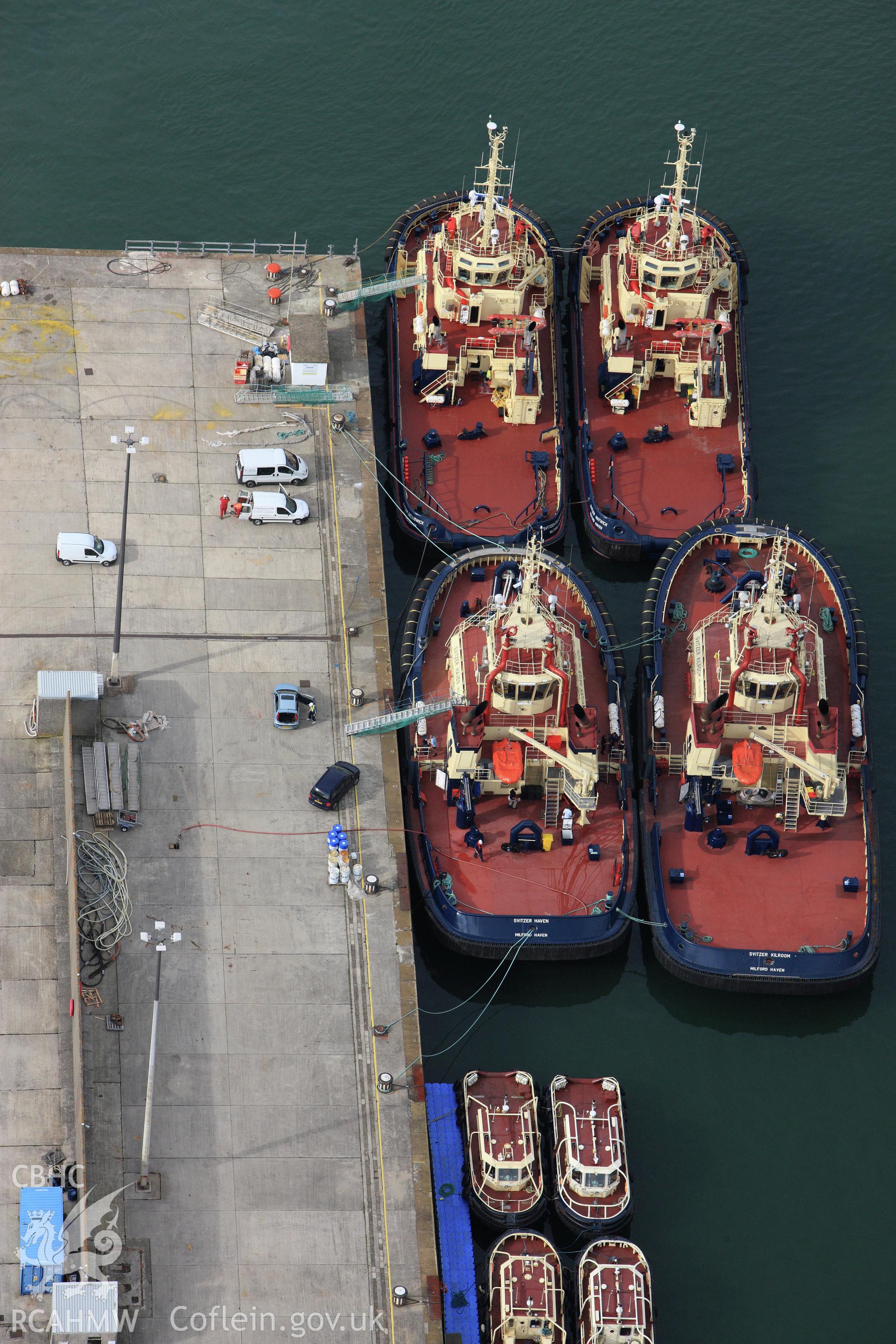 RCAHMW colour oblique aerial photograph of The Royal Dockyard at Pembroke Dock showing Port Authority tugs. Taken on 14 October 2009 by Toby Driver