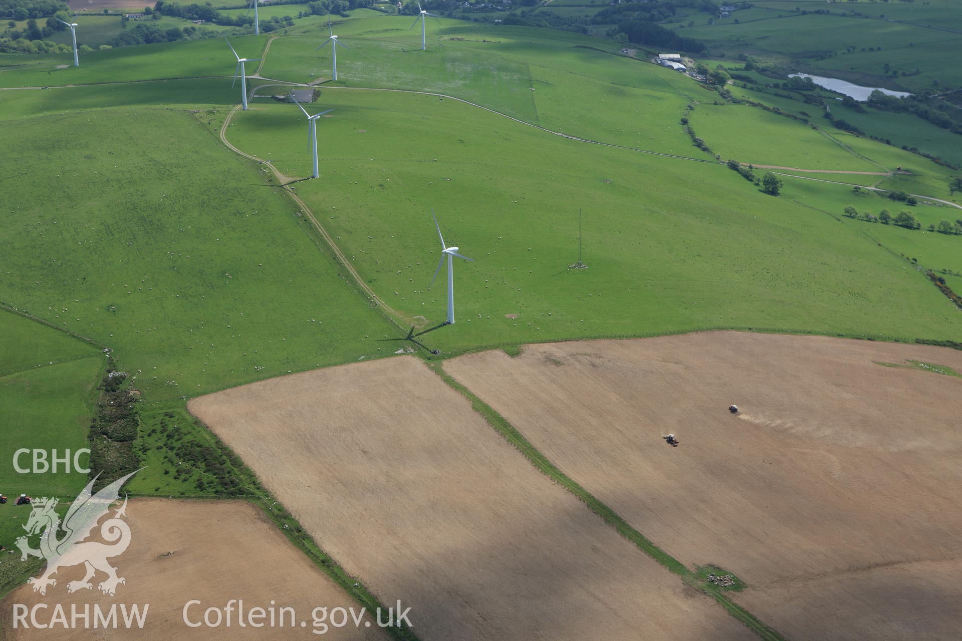 RCAHMW colour oblique aerial photograph of Mynydd Gorddu Wind Farm and ploughing, Elerch, Tal-y-Bont. Taken on 02 June 2009 by Toby Driver