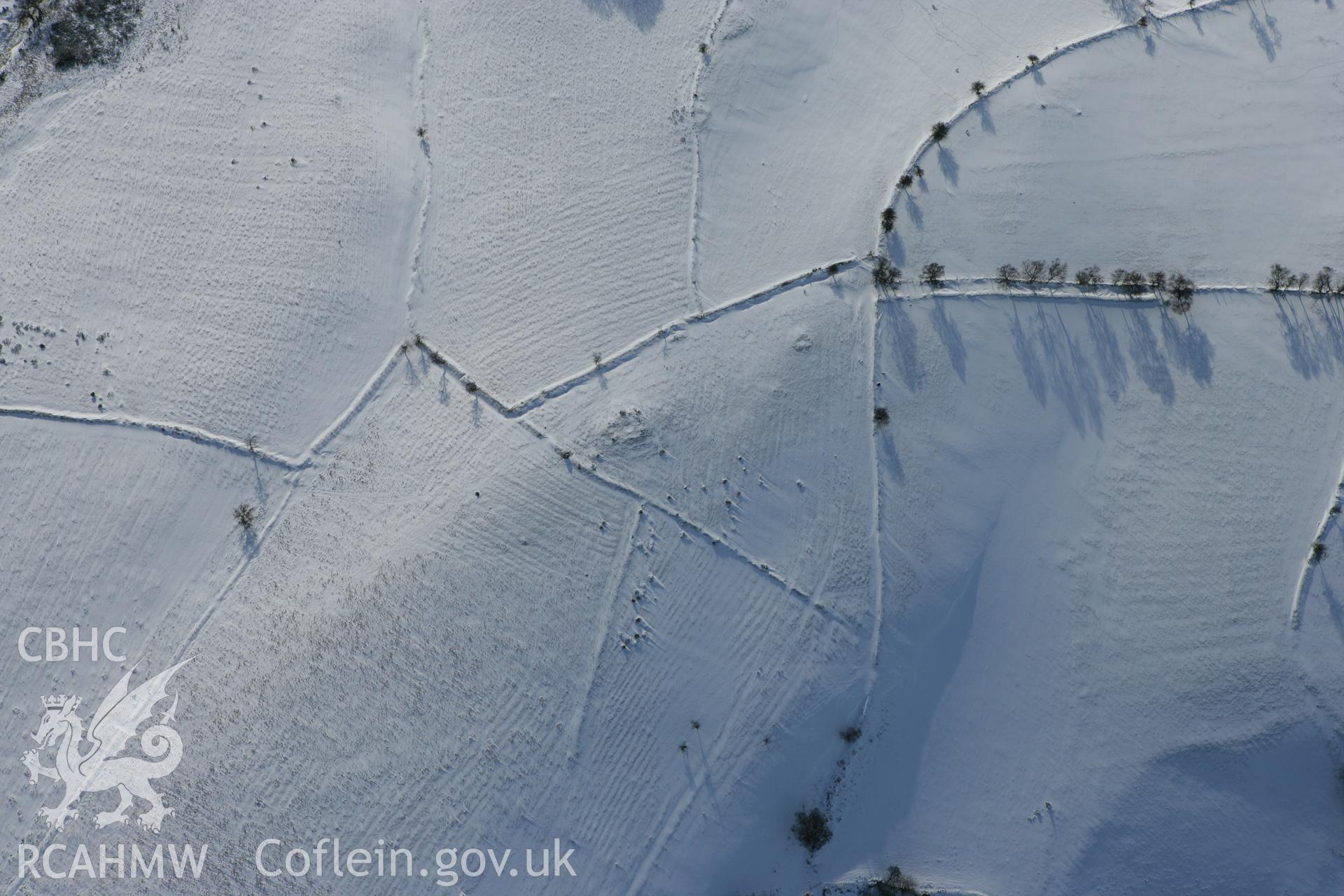 RCAHMW colour oblique photograph of round cairns and standing stone, south of Tyle-Pengam. Taken by Toby Driver on 06/02/2009.