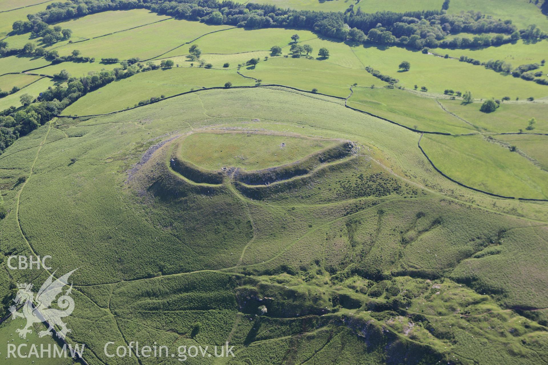 RCAHMW colour oblique aerial photograph of Crug Hywel Camp. Taken on 11 June 2009 by Toby Driver