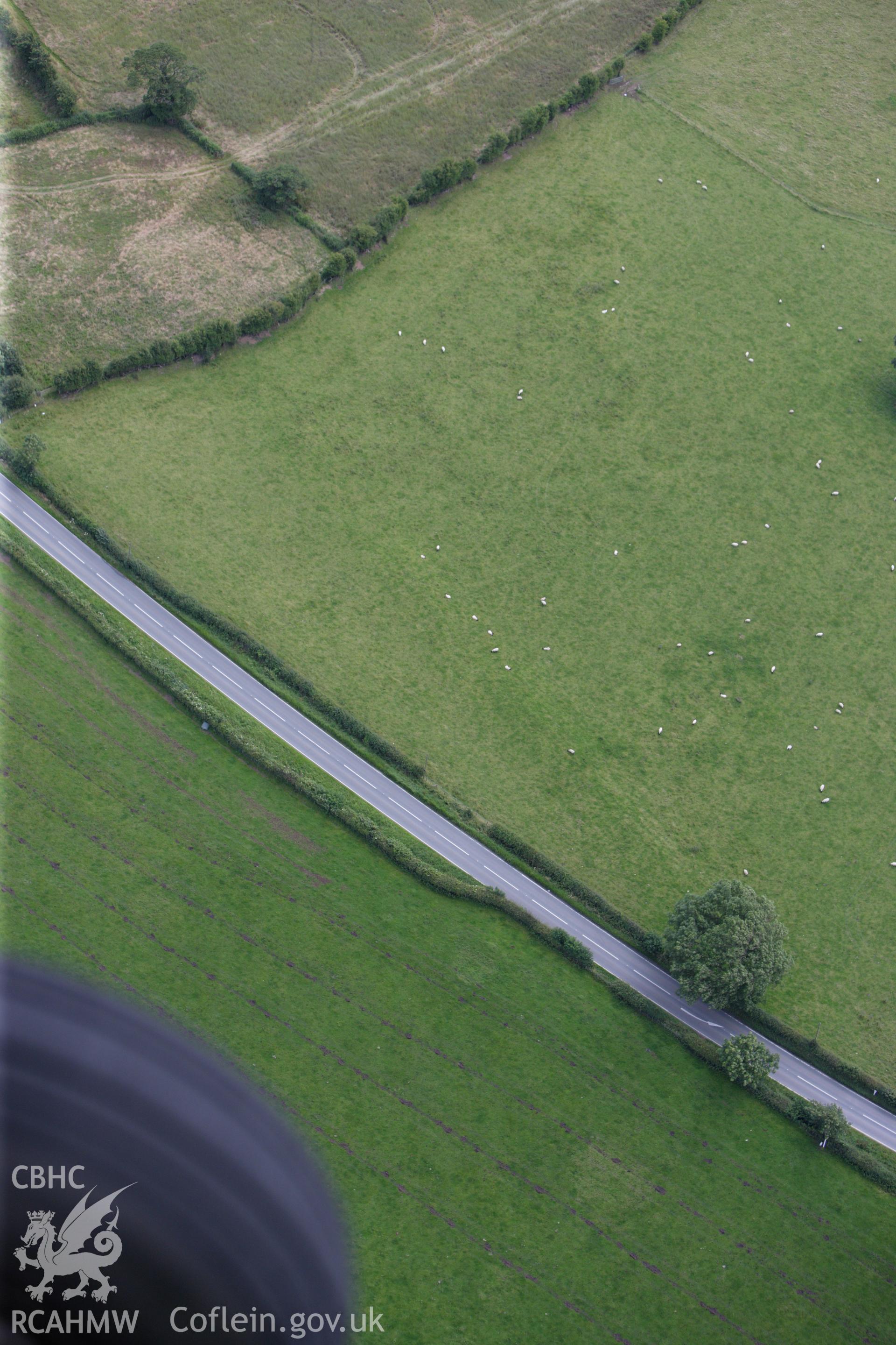 RCAHMW colour oblique aerial photograph of a section of Offa's Dyke, or Whitford Dyke, northwest and southeast of Brynbella Mound. Taken on 30 July 2009 by Toby Driver