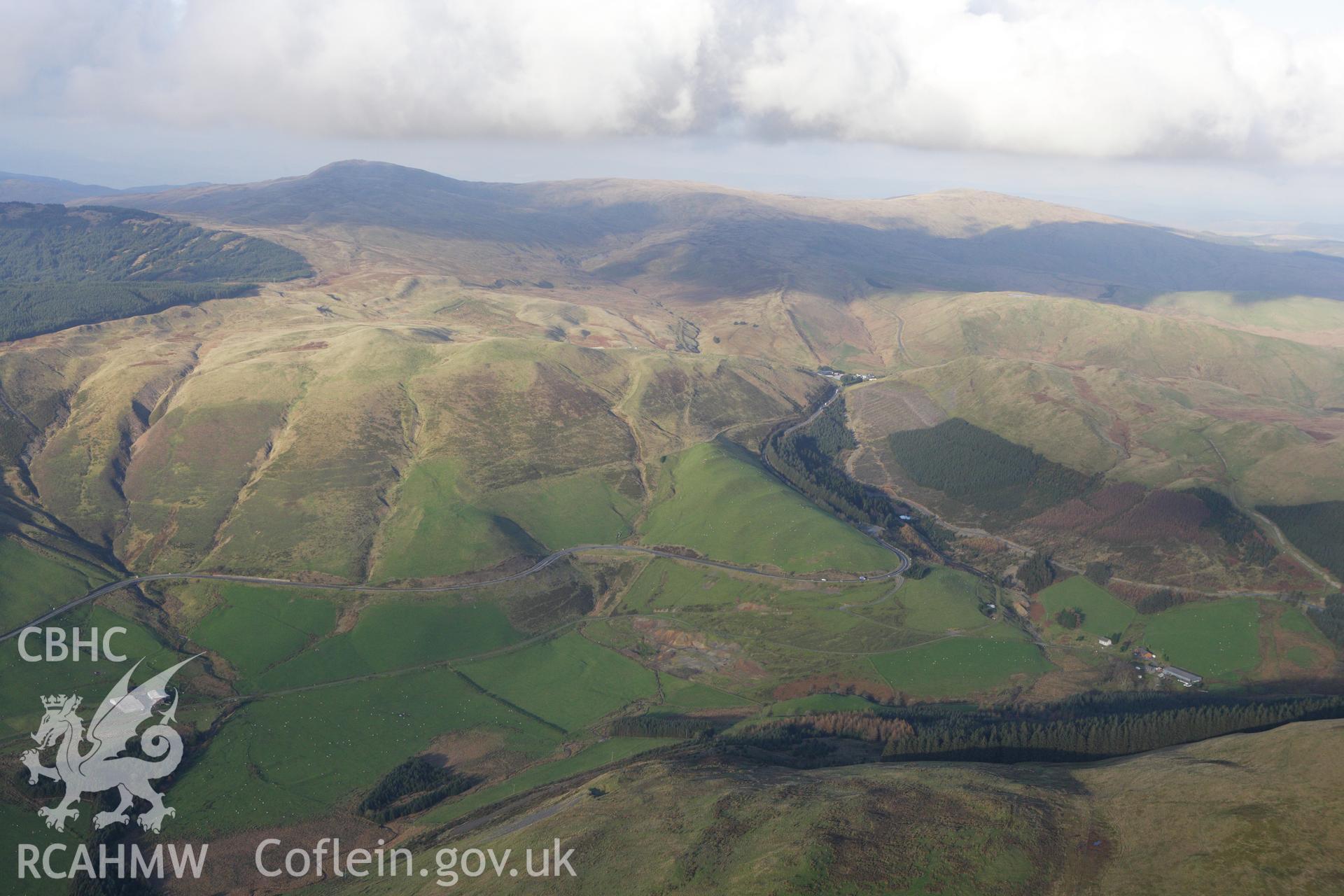 RCAHMW colour oblique aerial photograph of Esgair Lle Lead Mine, Eisteddfa Gurig, and the surrounding landscape from the south-west. Taken on 09 November 2009 by Toby Driver