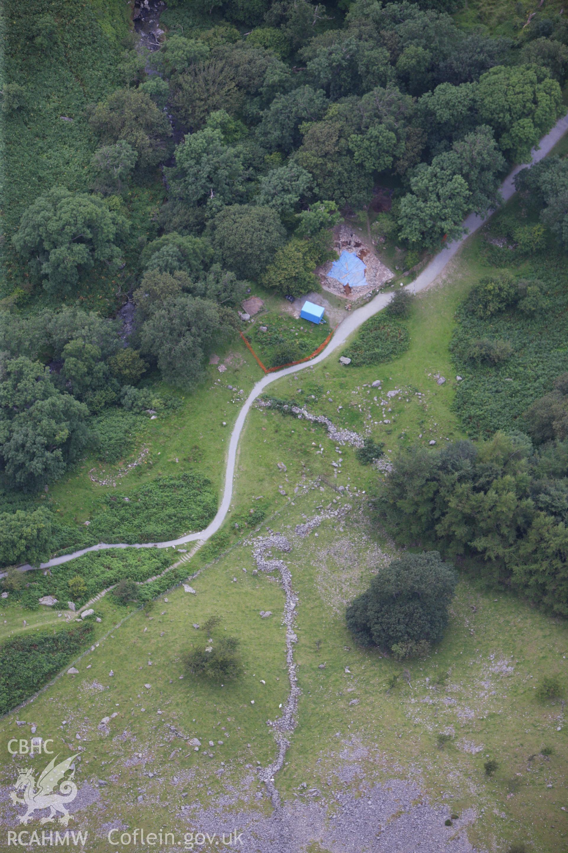 RCAHMW colour oblique aerial photograph of the excavated Hut Circle in Aber Valley. Taken on 06 August 2009 by Toby Driver