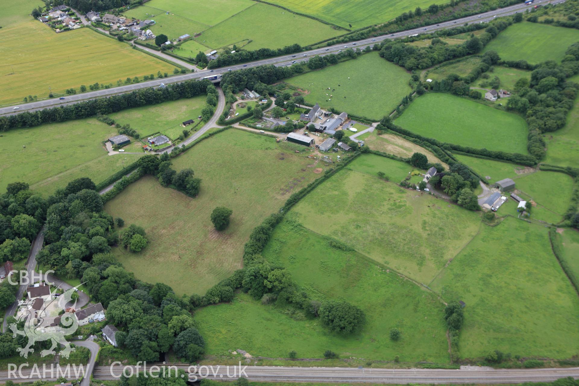 RCAHMW colour oblique aerial photograph of Miskin Roman Fort. Taken on 09 July 2009 by Toby Driver