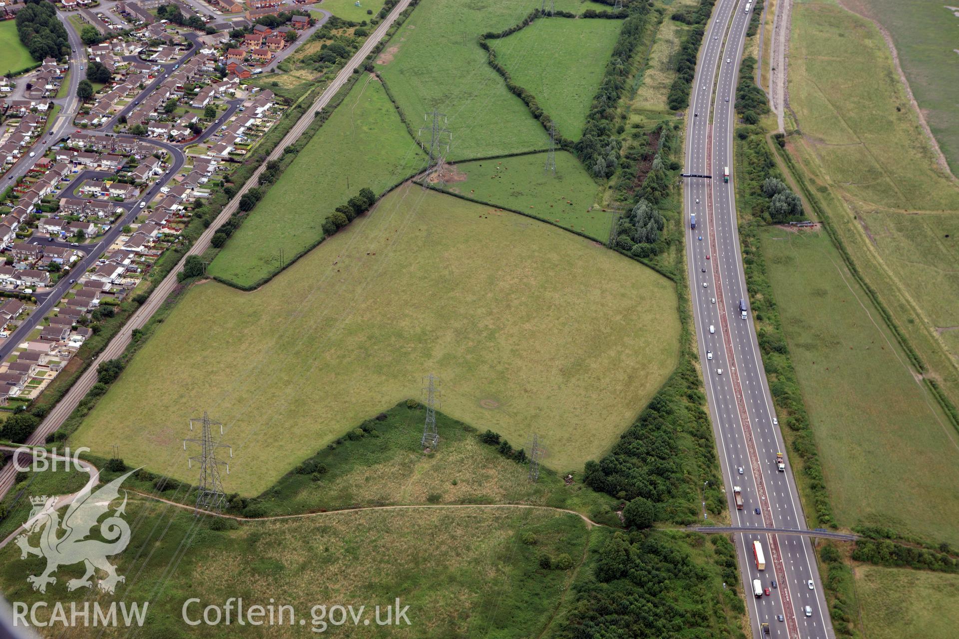 RCAHMW colour oblique aerial photograph of Stoop Hill cropmark enclosure or Roman Villa, Caldicot. Taken on 09 July 2009 by Toby Driver