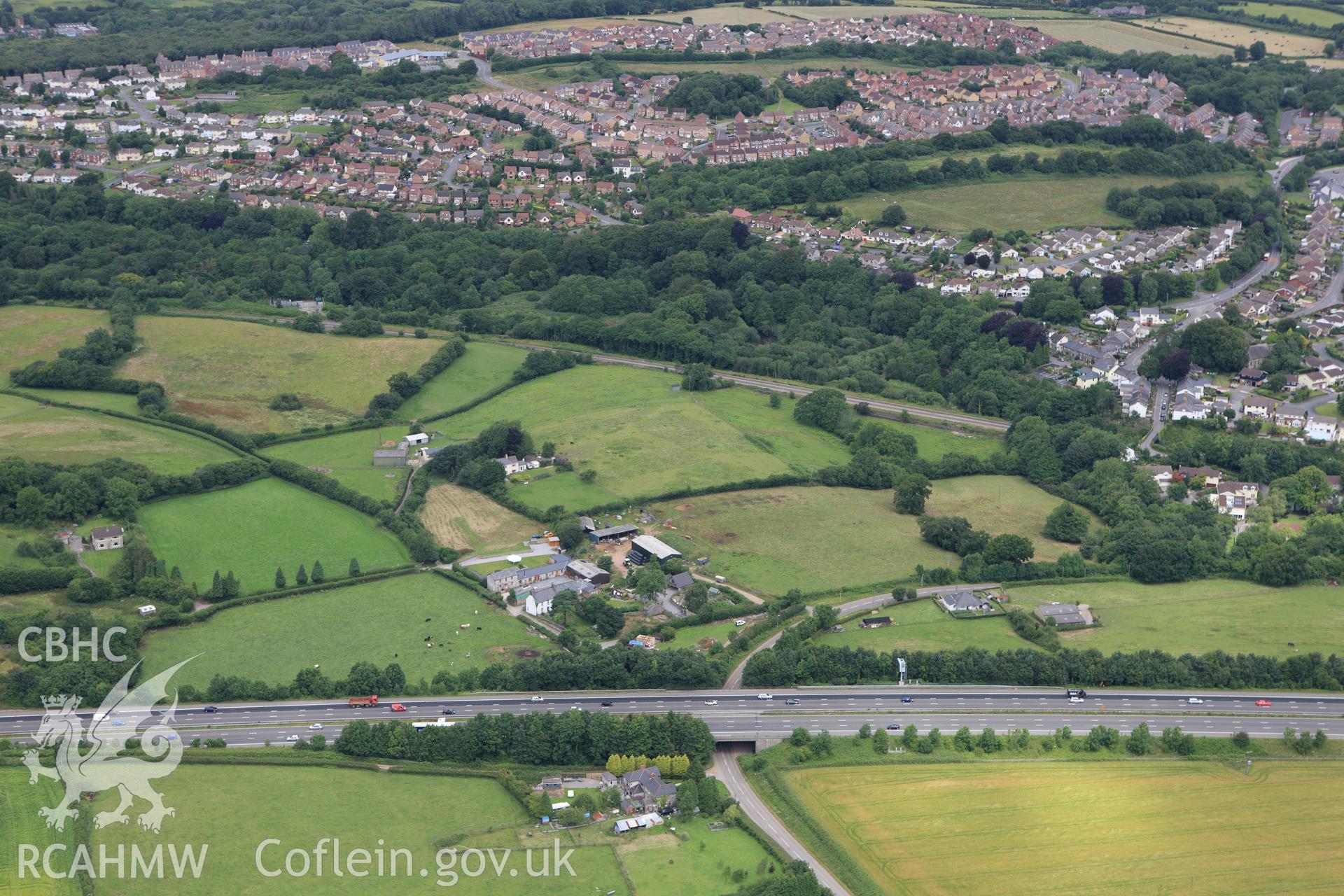 RCAHMW colour oblique aerial photograph of Miskin Roman Fort. Taken on 09 July 2009 by Toby Driver