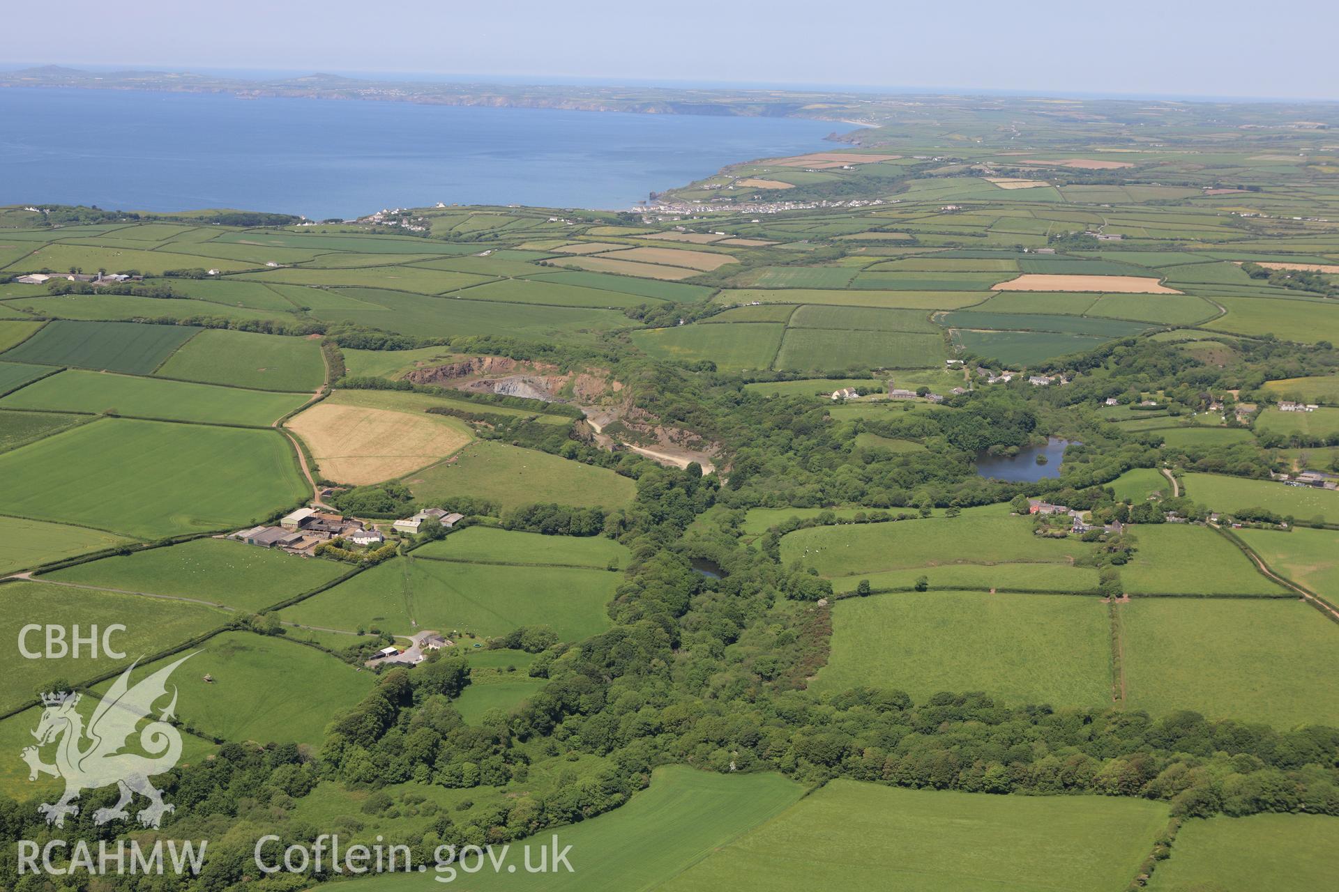 RCAHMW colour oblique aerial photograph of Syke Rath Promontory Fort. A wide view. Taken on 01 June 2009 by Toby Driver