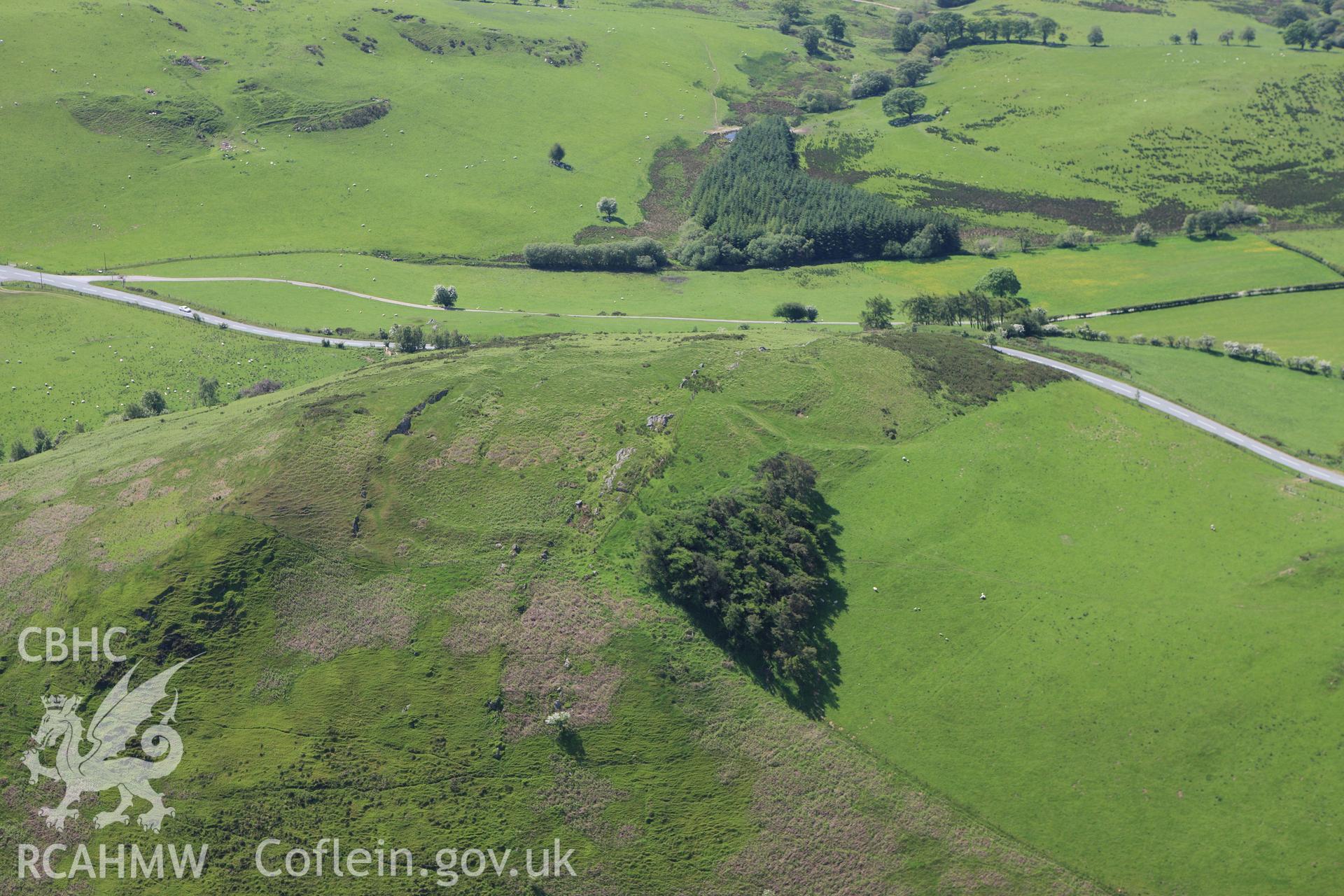 RCAHMW colour oblique aerial photograph of Pen-y-Clun Hillfort. Taken on 02 June 2009 by Toby Driver