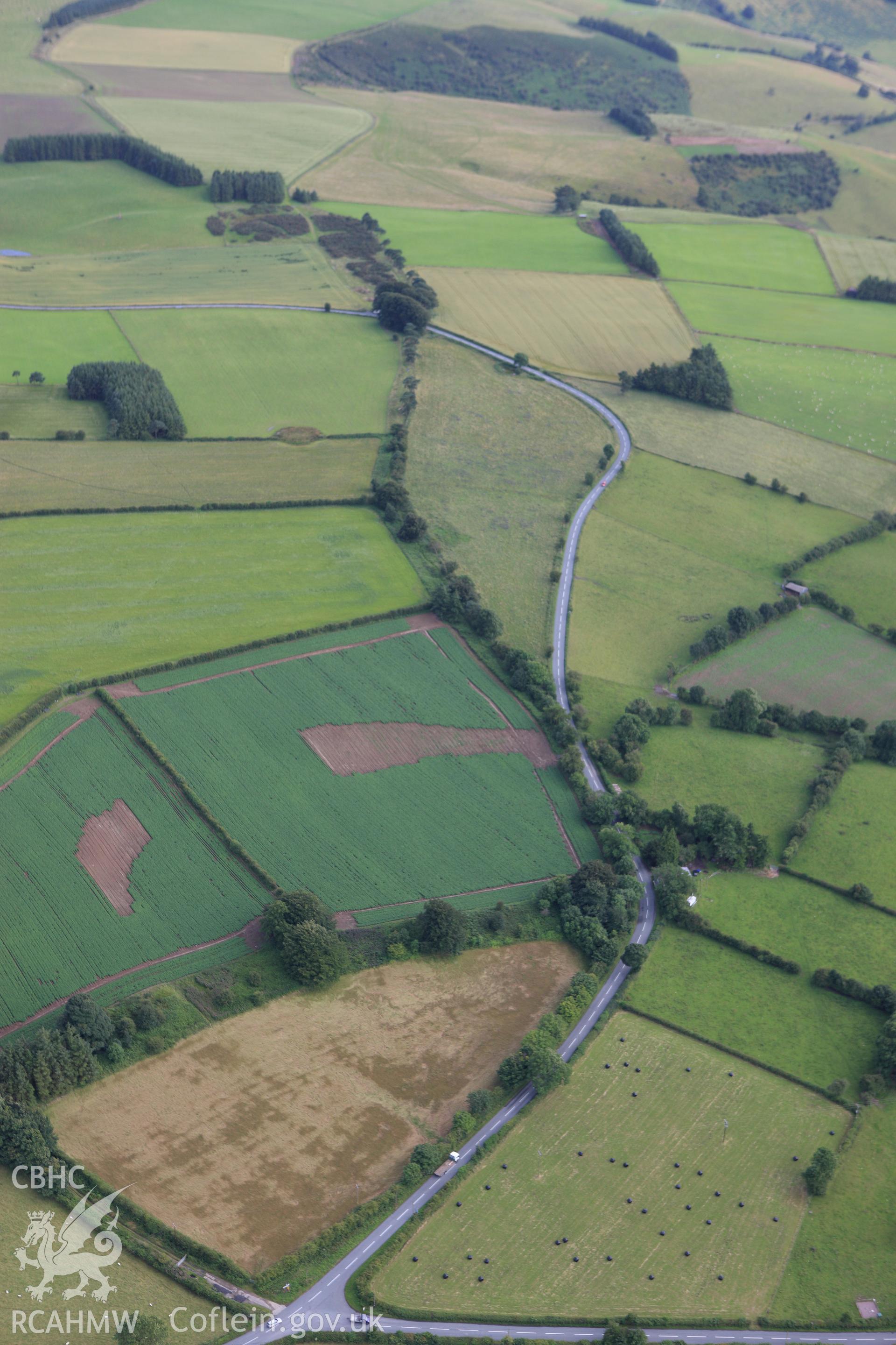 RCAHMW colour oblique aerial photograph of a section of Offa's Dyke extending 2143m south from The Firs, Rhos-y-Meirch. Taken on 23 July 2009 by Toby Driver