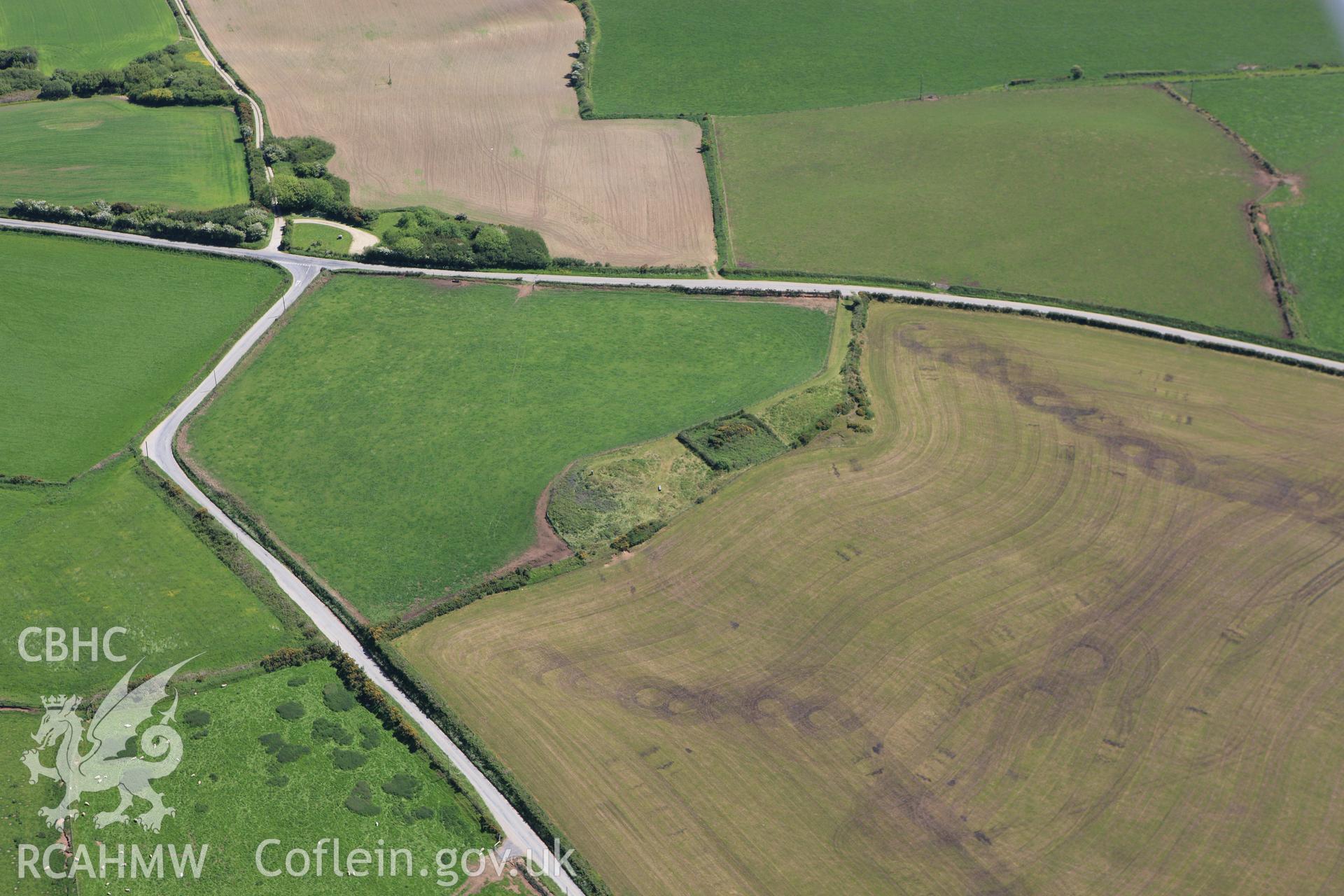 RCAHMW colour oblique aerial photograph of Crugiau Cemaes Barrow II. Taken on 01 June 2009 by Toby Driver