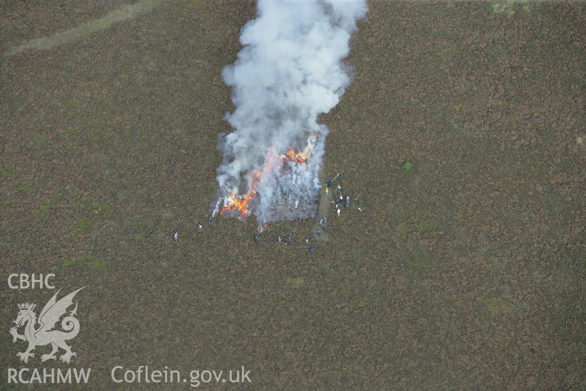 RCAHMW colour oblique aerial photograph of Foel Fenlli Hillfort showing a controlled heather burn. Taken on 13 October 2009 by Toby Driver